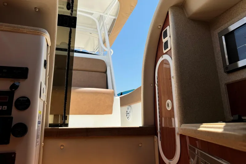 Slide: The Image of Interior view of a 2010 Deep Impact 36 DI boat, featuring seating and control panels. - 35