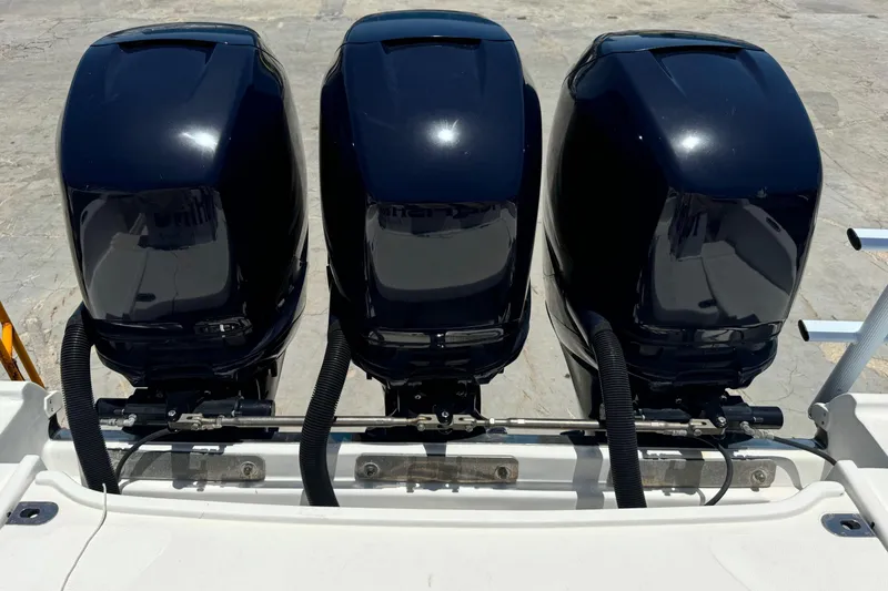Slide: The Image of Three powerful outboard motors on a 2010 Deep Impact 36 DI boat. - 39