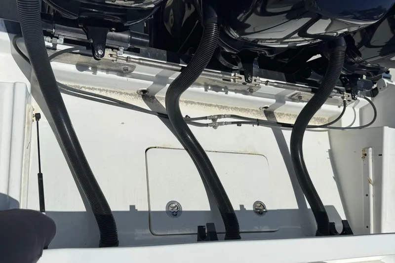 Slide: The Image of Engine compartment of a 2010 Deep Impact 36 DI boat, showing hoses and components. - 40