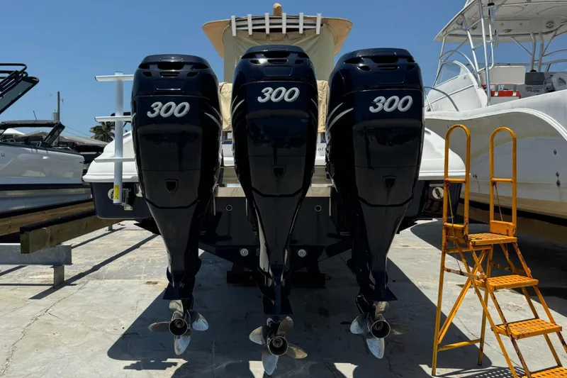 Slide: The Image of Triple 300 horsepower outboard motors on a 2010 Deep Impact 36 DI boat, dockside. - 41