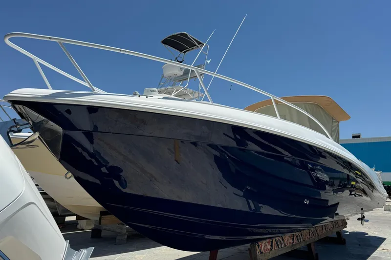 Slide: The Image of Deep Impact 36 DI 2010 boat with sleek design, docked under clear blue sky. - 43