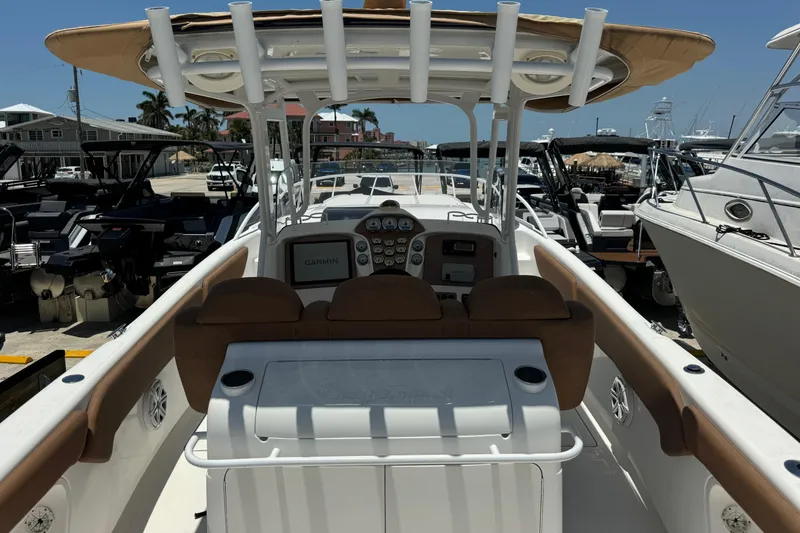 Slide: The Image of 2010 Deep Impact 36 DI boat interior with helm, controls, and seating in a marina setting. - 7