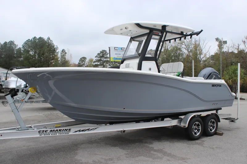 The Image of 2025 Sea Fox 228 Commander boat on trailer, gray hull, parked outdoors. - 1