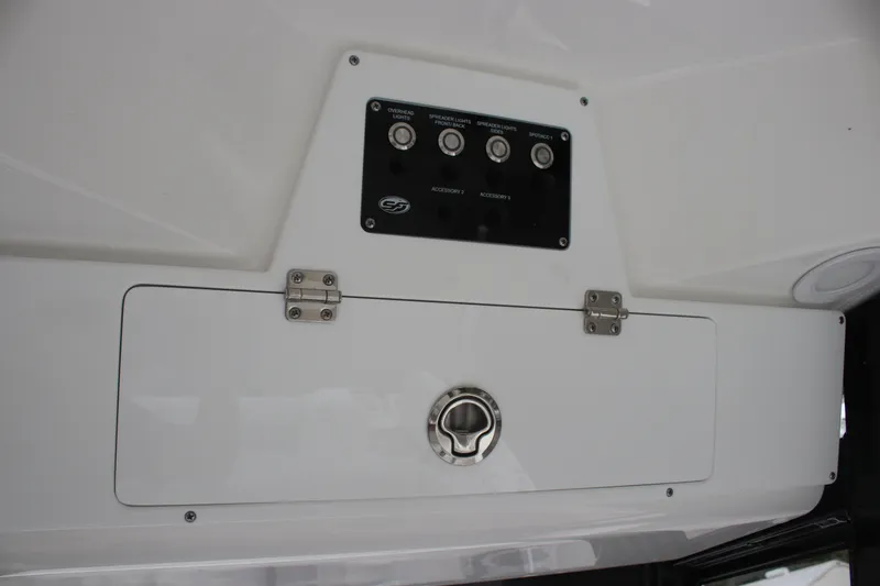 Slide: The Image of Control panel on 2025 Sea Fox 228 Commander boat, featuring switches and storage compartment. - 16