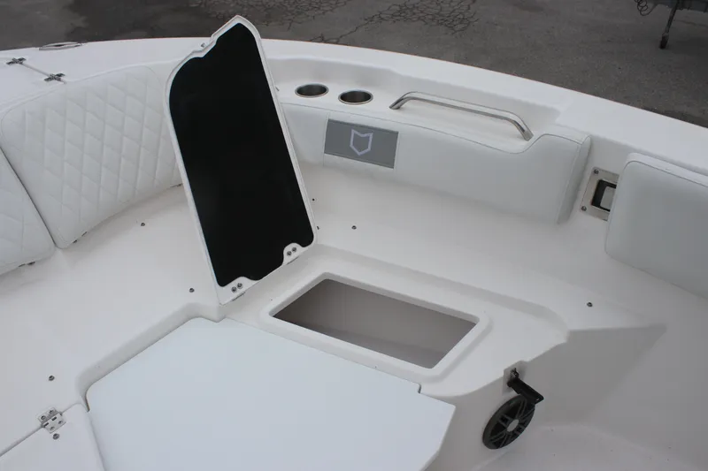 Slide: The Image of 2025 Sea Fox 228 Commander boat interior with open storage compartment and cushioned seating. - 19