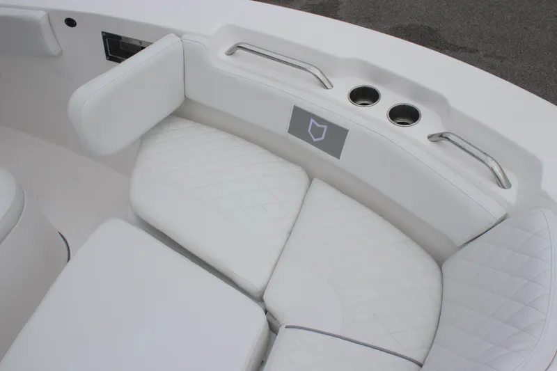 Slide: The Image of 2025 Sea Fox 228 Commander boat interior with white cushioned seating and cup holders. - 24