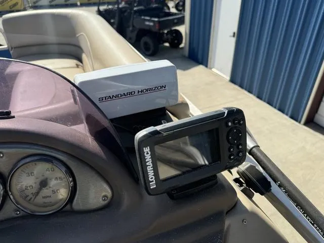 Slide: The Image of 2014 SunCatcher V322 RC boat dashboard with Lowrance and Standard Horizon devices. - 14