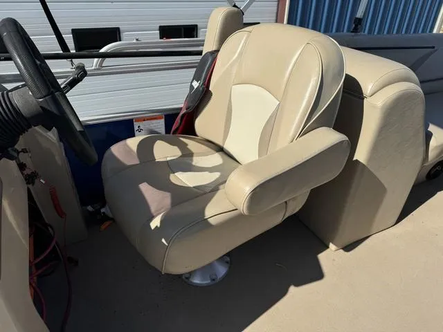 Slide: The Image of Captain's chair on a 2014 SunCatcher V322 RC boat, beige upholstery, steering wheel visible. - 19