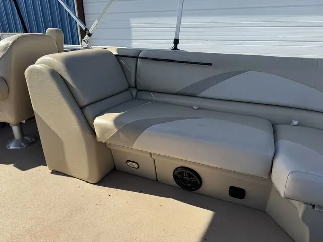 Slide: The Image of 2014 SunCatcher V322 RC boat interior with beige seating and speaker. - 20