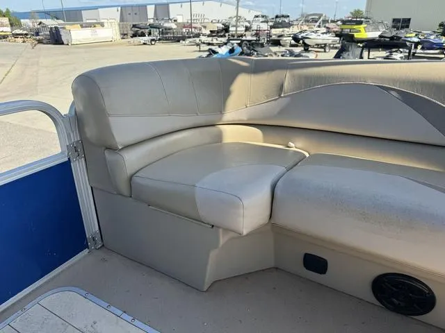 Slide: The Image of 2014 SunCatcher V322 RC boat with beige seating, docked in a marina. - 22