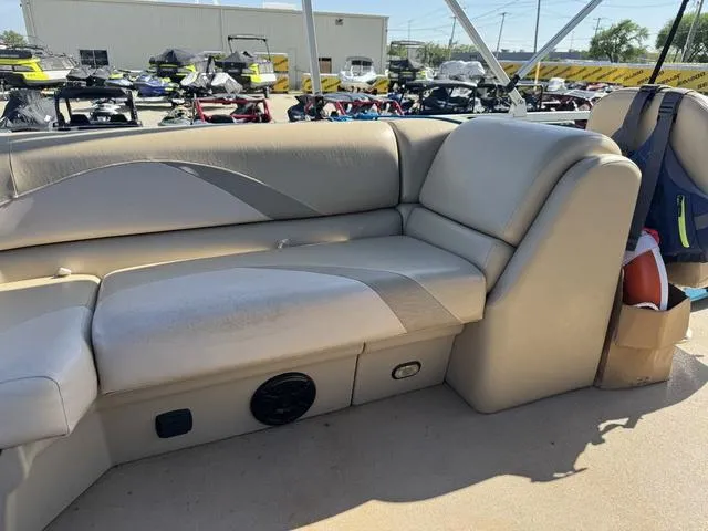 Slide: The Image of 2014 SunCatcher V322 RC boat interior with beige seating and storage compartments. - 23