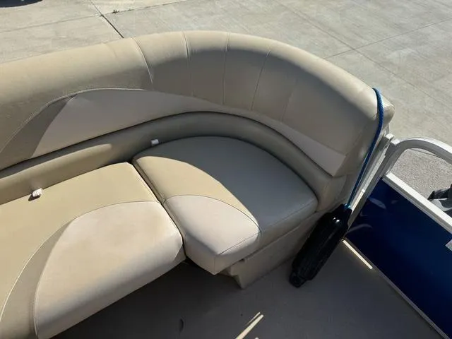 Slide: The Image of 2014 SunCatcher V322 RC boat seating with beige upholstery in sunlight. - 28