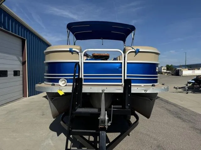 Slide: The Image of 2014 SunCatcher V322 RC pontoon boat on trailer, blue and beige, parked outdoors. - 3