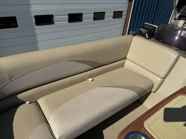 Slide: The Image of 2014 SunCatcher V322 RC boat interior with beige seating and cup holder. - 30
