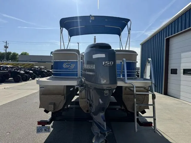 Slide: The Image of 2014 SunCatcher V322 RC pontoon boat with Yamaha 150 engine, parked near a blue building. - 7