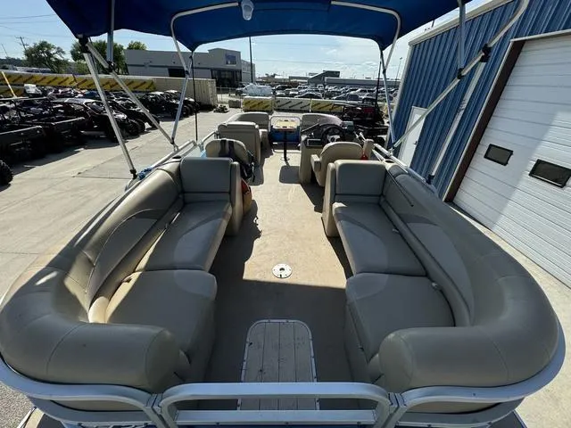Slide: The Image of 2014 SunCatcher V322 RC pontoon boat with spacious seating and blue canopy, docked outdoors. - 9