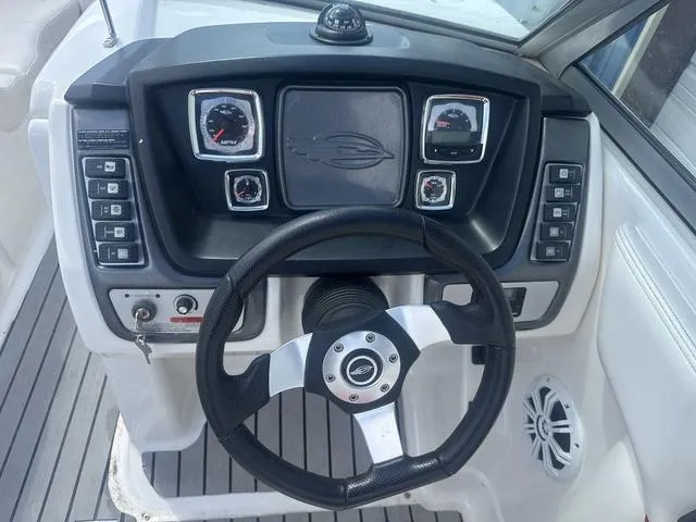 Slide: The Image of 2008 Chaparral Sunesta 224 boat dashboard with steering wheel and gauges. - 10