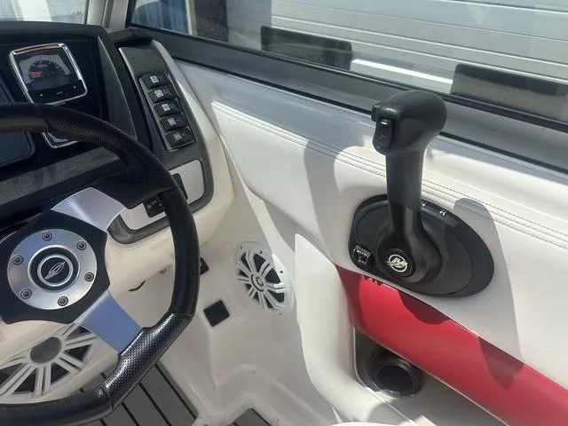 Slide: The Image of 2008 Chaparral Sunesta 224 boat dashboard with steering wheel and throttle controls. - 11