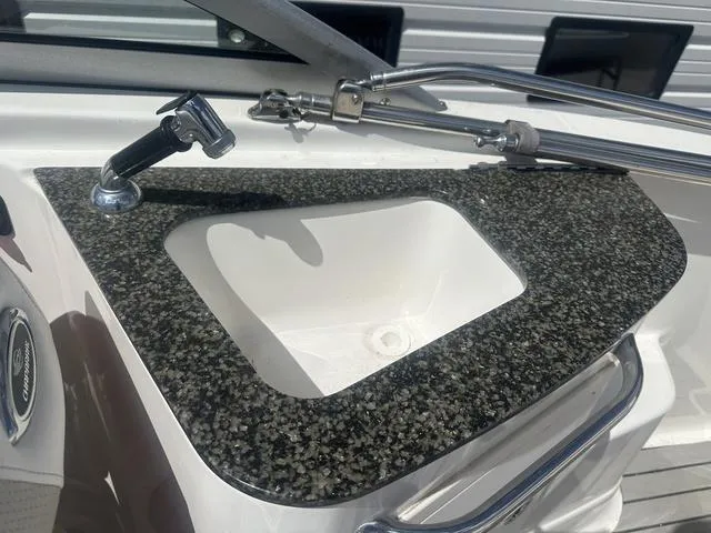 Slide: The Image of 2008 Chaparral Sunesta 224 boat sink with granite countertop and faucet. - 13