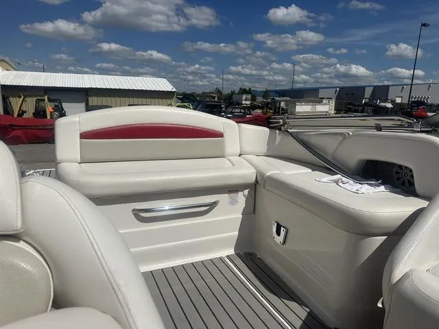 Slide: The Image of 2008 Chaparral Sunesta 224 boat interior with white seating and red accents under a blue sky. - 15