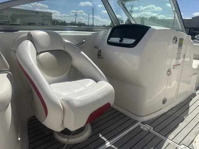 Slide: The Image of 2008 Chaparral Sunesta 224 boat interior with white captain's chair and dashboard. - 16