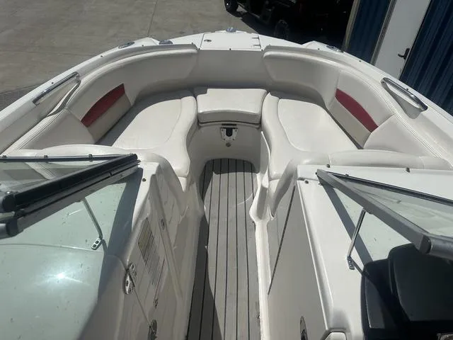 Slide: The Image of 2008 Chaparral Sunesta 224 boat interior with white seating and red accents. - 17