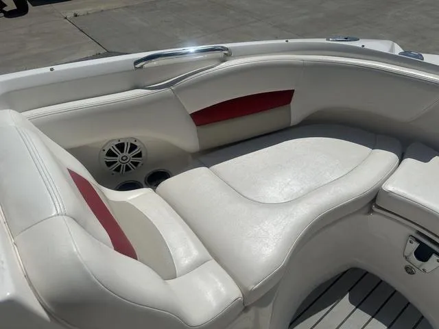 Slide: The Image of 2008 Chaparral Sunesta 224 boat interior with white and red seating, cup holders, and speaker. - 18