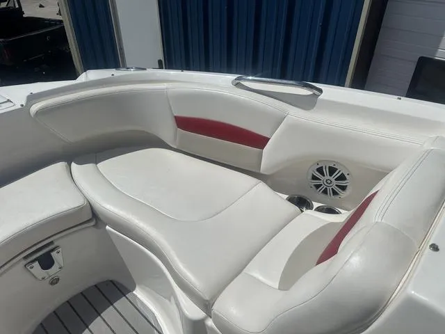 Slide: The Image of 2008 Chaparral Sunesta 224 boat interior with white and red seating, speaker, and cup holders. - 19