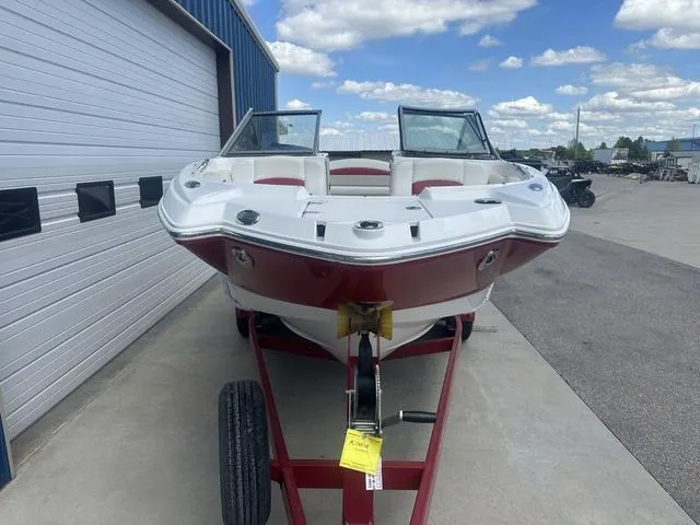 Slide: The Image of 2008 Chaparral Sunesta 224 boat on trailer, parked outdoors under a blue sky. - 3
