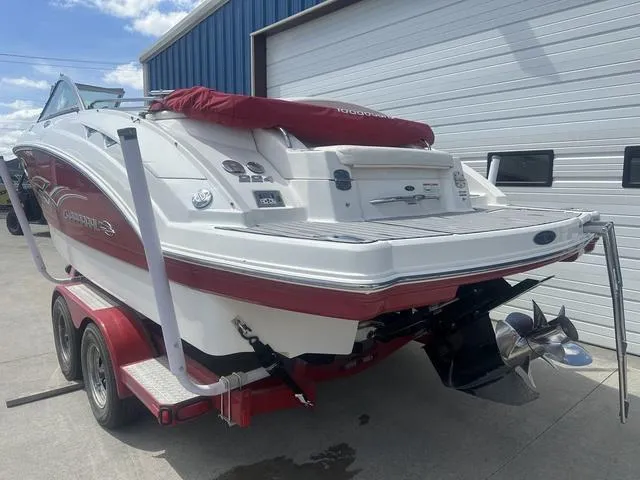 Slide: The Image of 2008 Chaparral Sunesta 224 boat on trailer, red and white design, parked outdoors. - 6