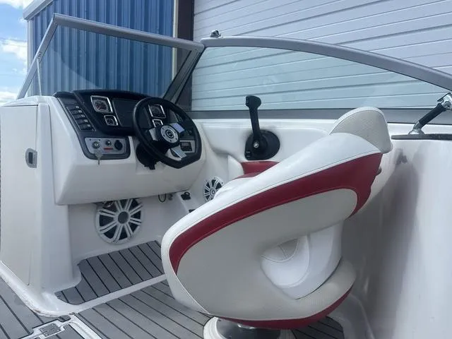 Slide: The Image of 2008 Chaparral Sunesta 224 boat interior with steering wheel and captain's chair. - 9