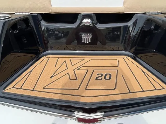 Slide: The Image of 2024 MasterCraft XT20 boat deck with logo and emblem detailing. - 12