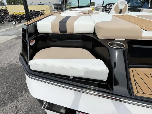 Slide: The Image of 2024 MasterCraft XT20 boat with beige and white seating, cup holder, and sleek design. - 14