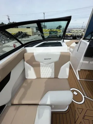 Slide: The Image of 2024 MasterCraft XT20 boat interior with beige and white seating, featuring modern design elements. - 26