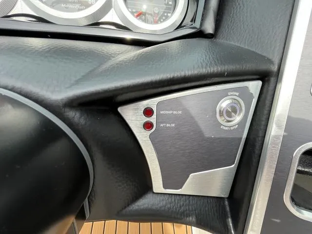 Slide: The Image of 2024 MasterCraft XT20 dashboard with engine start/stop button and control panel. - 32