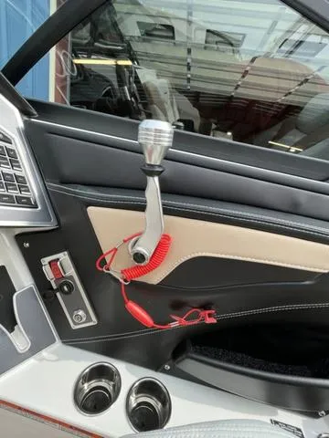 Slide: The Image of 2024 MasterCraft XT20 boat interior with throttle control and cup holders. - 35