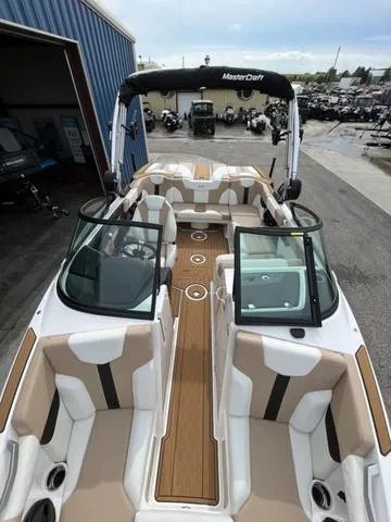Slide: The Image of 2024 MasterCraft XT20 boat with sleek interior and open deck design. - 42