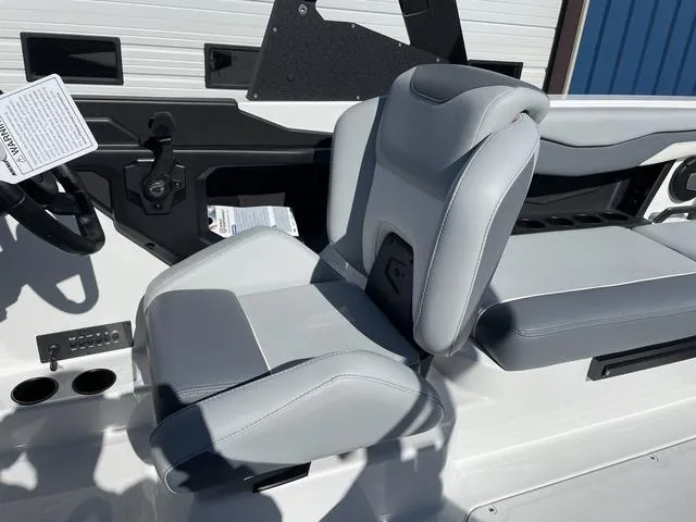 Slide: The Image of 2024 Axis Wake Research T220-R boat interior with gray seating and steering wheel. - 19