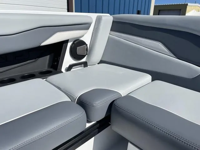 Slide: The Image of 2024 Axis Wake Research T220-R boat interior with gray seating and speaker detail. - 21