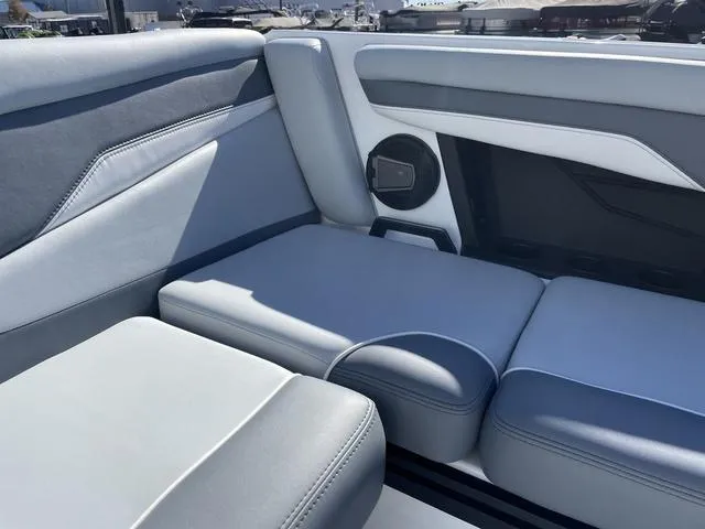 Slide: The Image of 2024 Axis Wake Research T220-R boat interior with gray seating and speaker. - 24