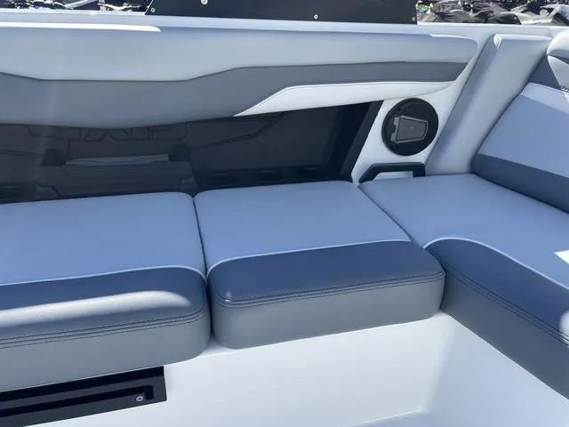 Slide: The Image of 2024 Axis Wake Research T220-R boat interior with gray seating and speaker. - 26