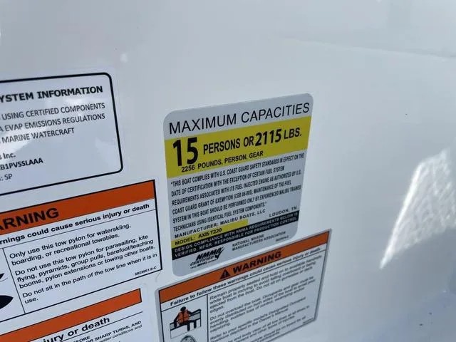 Slide: The Image of 2024 Axis Wake Research T220-R capacity label, max 15 persons or 2115 lbs, safety warnings. - 28