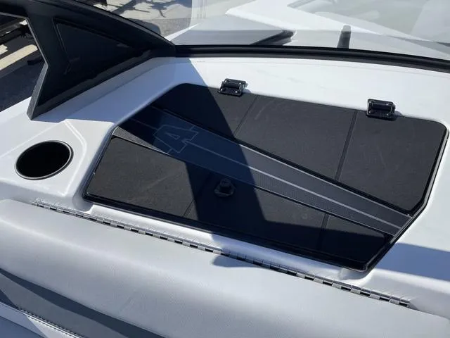 Slide: The Image of 2024 Axis Wake Research T220-R boat interior with storage compartment and cup holder. - 29
