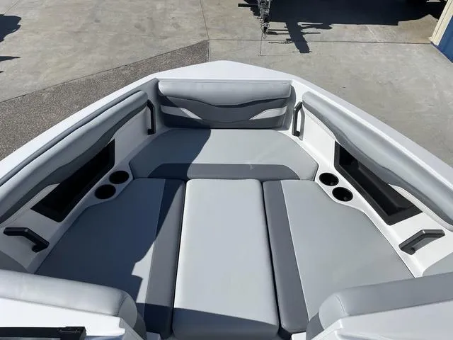 Slide: The Image of 2024 Axis Wake Research T220-R boat interior with gray seating and cup holders. - 30
