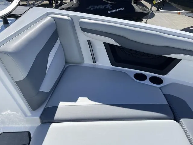 Slide: The Image of 2024 Axis Wake Research T220-R boat interior with gray seating and cup holders. - 32