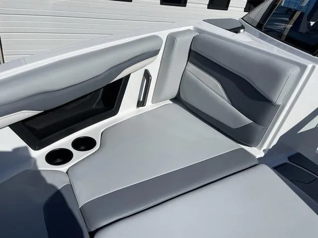 Slide: The Image of 2024 Axis Wake Research T220-R boat interior with gray seating and cup holders. - 33