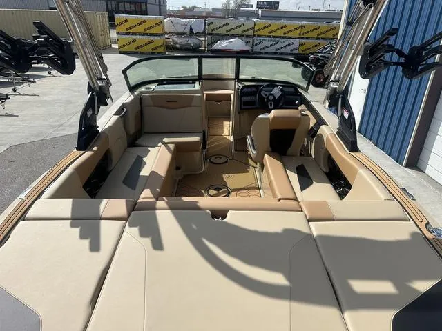 Slide: The Image of 2024 MasterCraft NXT21 boat interior with tan seating and modern dashboard. - 10