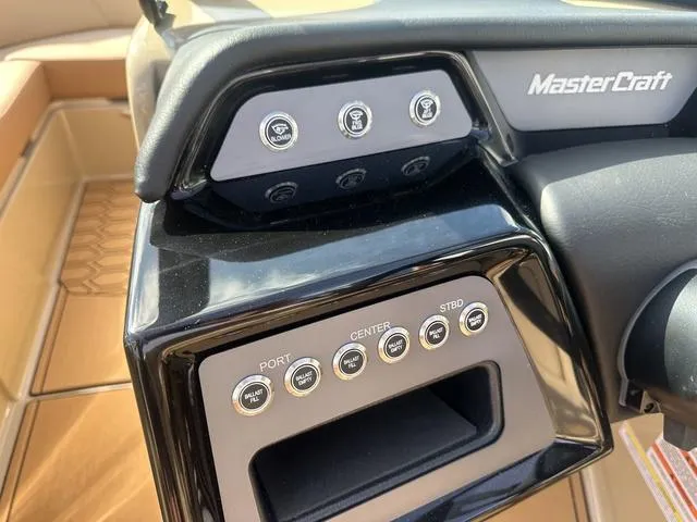 Slide: The Image of 2024 MasterCraft NXT21 boat dashboard with control buttons and sleek design. - 17