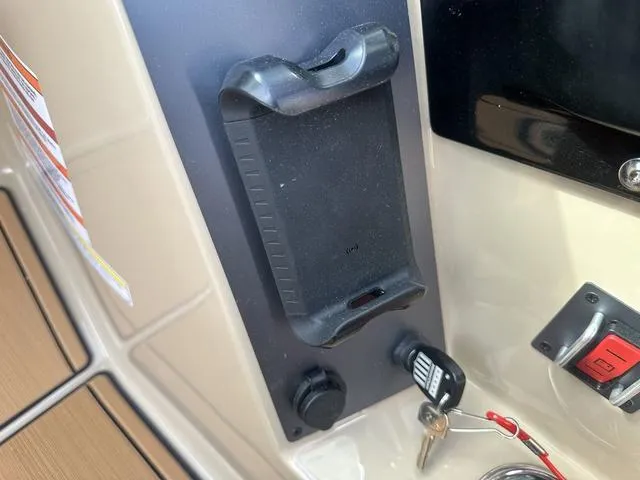 Slide: The Image of 2024 MasterCraft NXT21 dashboard with phone holder and ignition keys. - 19