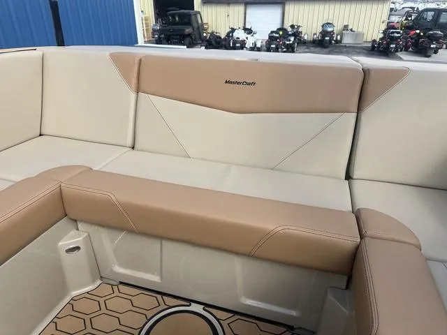 Slide: The Image of 2024 MasterCraft NXT21 boat interior with beige and tan seating, showcasing luxury design. - 21